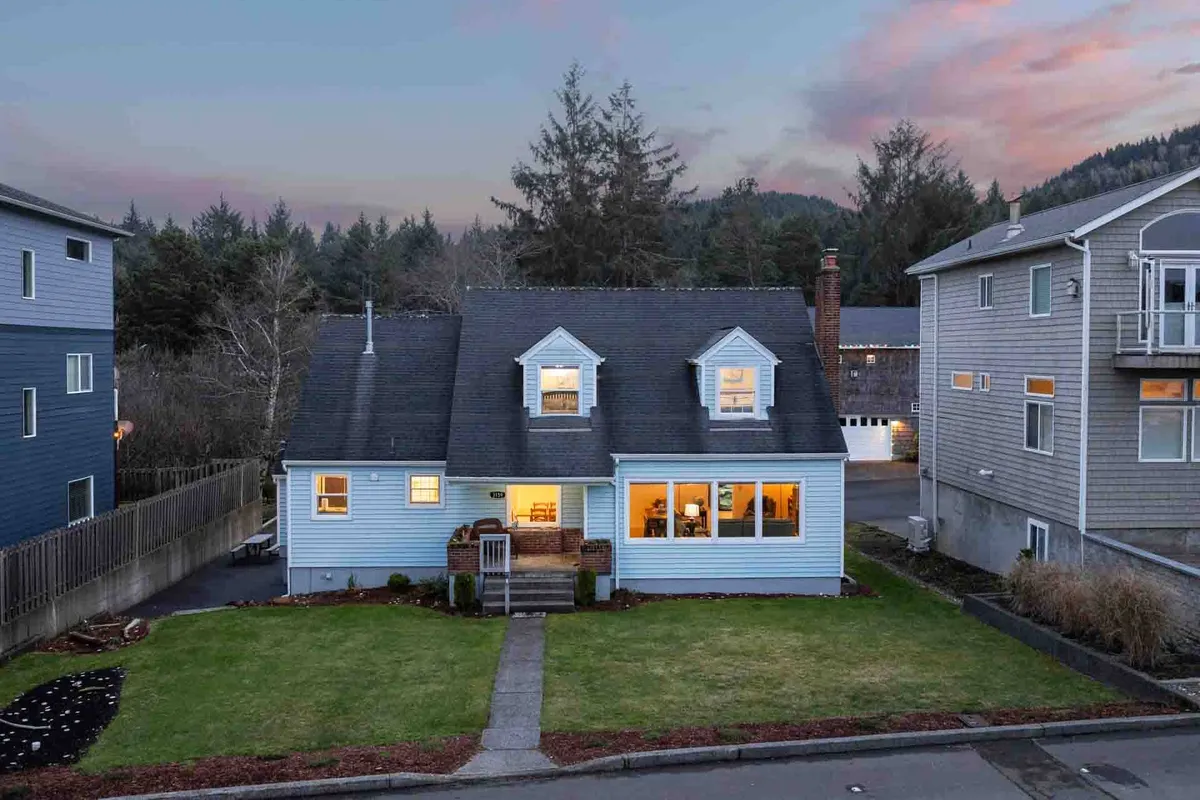 A bright and welcoming exterior shot featuring a spacious front porch with comfortable seating, large windows that let in plenty of natural light, and a beautifully landscaped yard. The scene conveys relaxation, inviting guests to enjoy the outdoors while remaining close to the comforts of home.